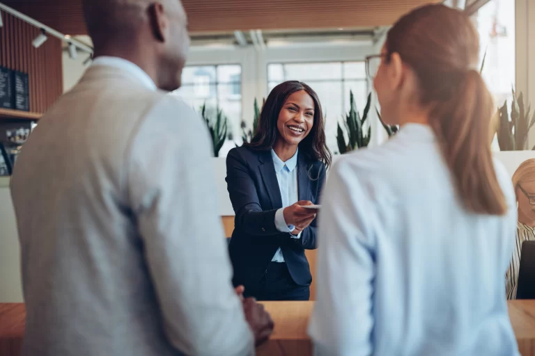 smiling-african-american-hotel-concierge-helping-g-2021-08-26-17-26-59-utc